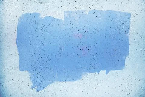 A rectangular swath of blue paint on a rough concrete wall, showing drips, .. Stock Photos