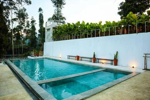 A rectangular swimming pool, creating a relaxing atmosphere Stock Photos
