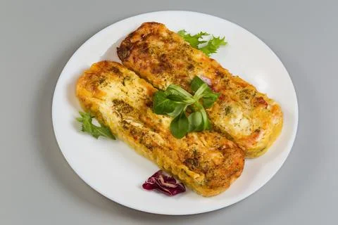 Rectangular vegetable casseroles with cheese on dish on gray background Fotos de archivo