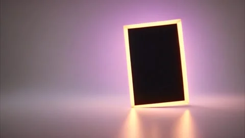 A rectangular vertical slanting gold frame with a black center on a blurred.. Vídeos de archivo 273954197