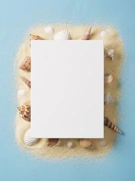 Rectangular white canvas lies on a sandy surface surrounded by white and br.. Stock Photos