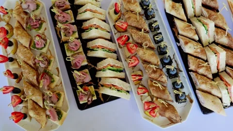 Rectangular white ceramic platters displaying gourmet appetizers, including mini Stockbeeldmateriaal 326144573