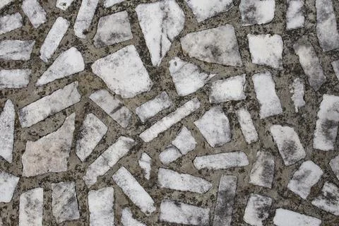 Rectangular white marble pieces on cement, aged mosaic structure backdrop Foto stock