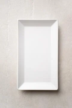Rectangular white plate on a light stone background Fotos de archivo