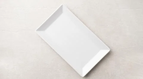 Rectangular white plate on a light stone background Fotos de archivo