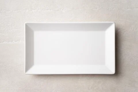 Rectangular white plate on a light stone background 스톡 사진