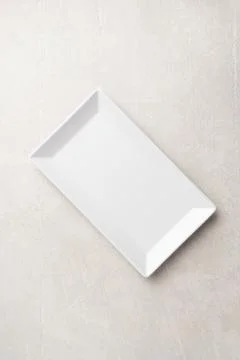 Rectangular white plate on a light stone background 스톡 사진
