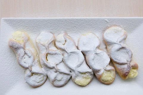 On rectangular white porcelain plate slowly sprinkle cottage cheese pies with 写真素材