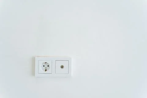 A rectangular white wall socket with a power plug and socket for electrical.. Stock Photos