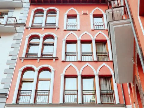 Rectangular windows with arched and domed decor on a coral wall Stock Photos