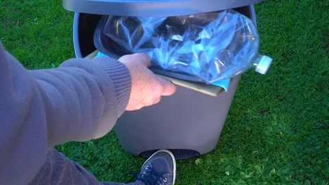Recyclable waste going into a step plastic trash can. Stock Footage 80759117