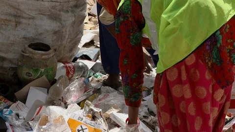 Recyclable waste pickers work on garbage separation, Stock Footage 128124153