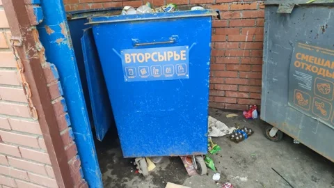 Recyclables, mixed waste, throwing a bag of garbage into a container Stock Footage 188743863