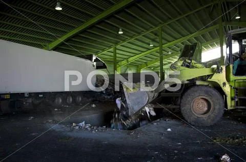 Recycle, overview of refuse collection with green bulldozer Stock Photos