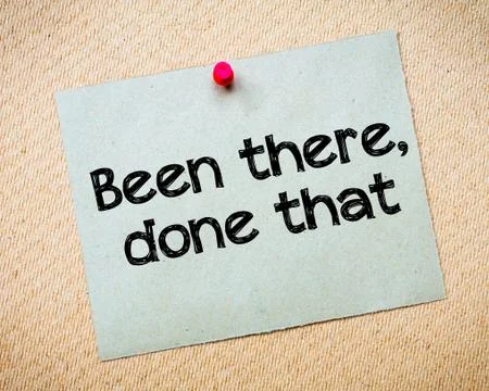 Recycled paper note with message pinned with red push pin on cork board Stock Photos