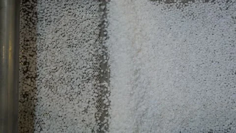 Recycled plastic granules on automatic shale shaker, conveyor belt - top view Stock Footage 158509938