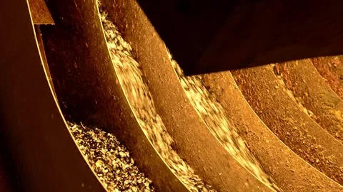Recycled plastic granules moving on a vibrating conveyor belt Stock Footage 332650196