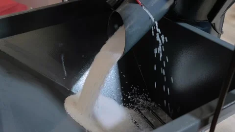 Recycled plastic granules, pellets falling into metal container Stock Footage 341313935