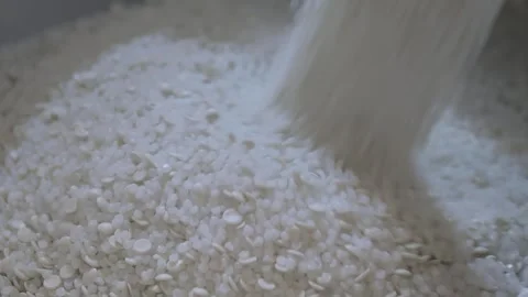 Recycled plastic granules, pellets falling into a large pile, heap - close up Stock Footage 341319797