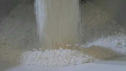 Recycled plastic granules, pellets falling into metal container Stock Footage 344690070