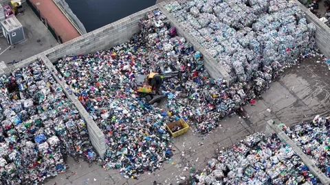 Recycling facility processes plastic waste near urban area Video stock 337983567
