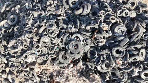 Recycling facility processing old car tires Stock Footage 294722816