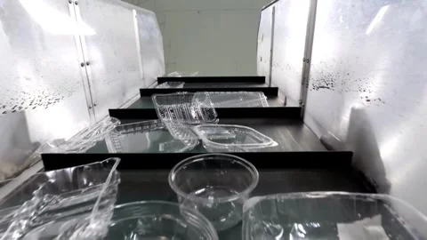 Recycling facility with used polypropylene containers moving slower on a Stock Footage 288185194