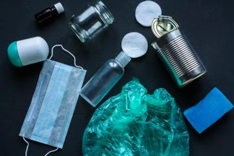 Recycling garbage is scattered on a dark surface. Stock Photos