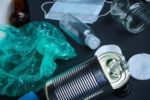Recycling garbage is scattered on a dark surface. Stock Photos