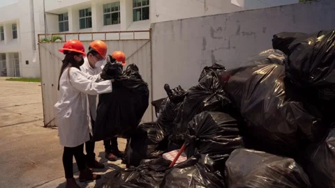 Recycling Plant Workers Moving Trash Bags for Processing Stock Footage 346643889