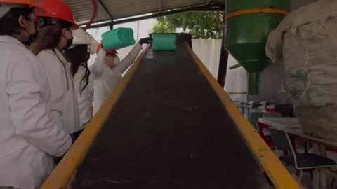 Recycling Plant Workers Process HDPE Plastic on Conveyor for Eco-Building Stock Footage 346643641