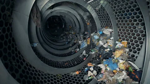 Recycling process at a plant. Rotating machine recycles trash in a waste center. Video stock 95041013
