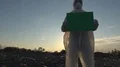 Recycling worker hold green table on the landfill  4k or 4k+ Resolution