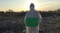 Recycling worker hold green table on the landfill  4k or 4k+ Resolution