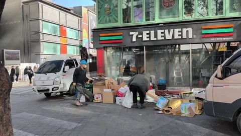 Recycling worker picking up recyclable material on street Stock Footage 302096661