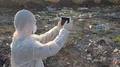Recycling worker with tablet on the landfill  4k or 4k+ Resolution