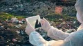 Recycling worker with tablet on the landfill  4k or 4k+ Resolution