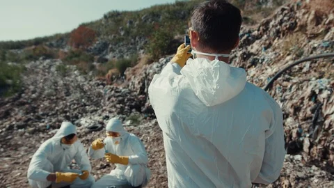 Recycling workers performing scientific research on landfill. Close-up young Video stock 113929632