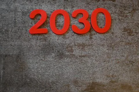 Red 2030 numerals on textured gray surface 스톡 사진