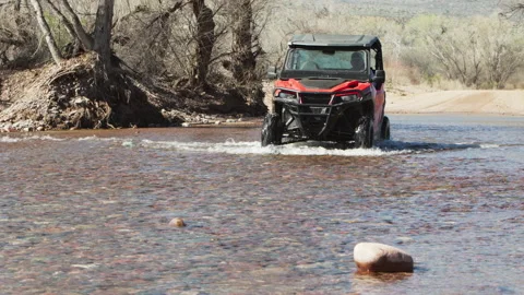 Red 4x4 buggy crossing the river. Stock Footage 213497867