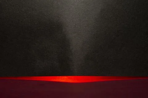 Red abstract light passing through black card making background Stock Photos