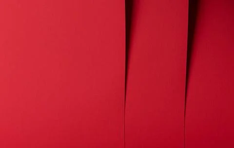 Red abstract paper background with vertical folds. Minimal textured surface f Stock Photos