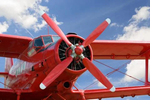 Red airplane biplane with piston engine Stock Photos