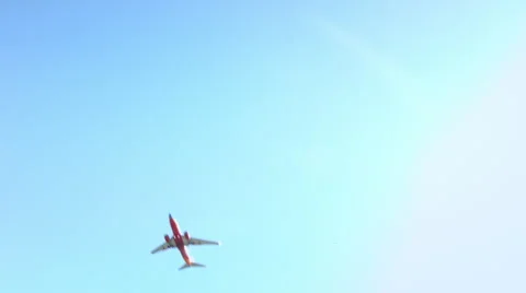 Red airplane flying in the sky Stock Footage 56785706