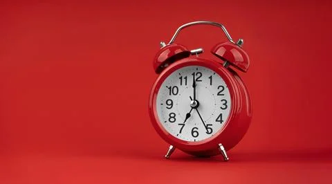 Red alarm clock on a red background. Stock Photos