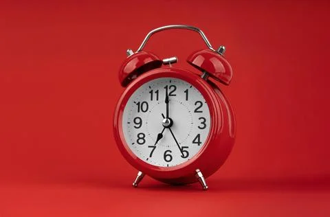 Red alarm clock on a red background. Stock Photos