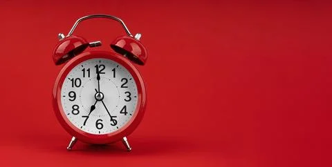 Red alarm clock on a red background. Stock Photos