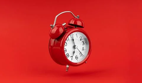 Red alarm clock on a red background. Stock Photos