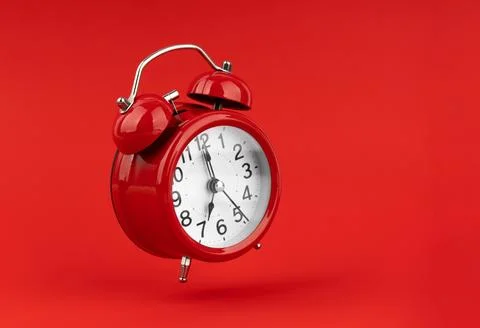 Red alarm clock on a red background. Stock Photos