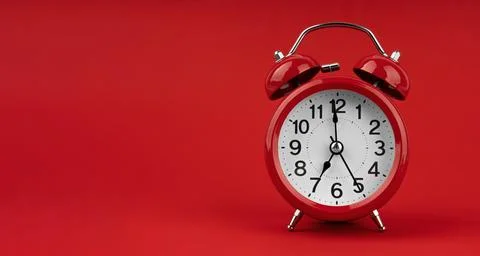 Red alarm clock on a red background. Stock Photos